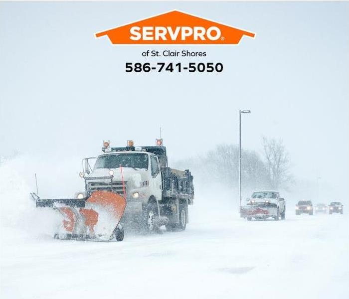 A snow plow clears a road.