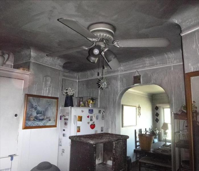 white walls covered in black soot in kitchen